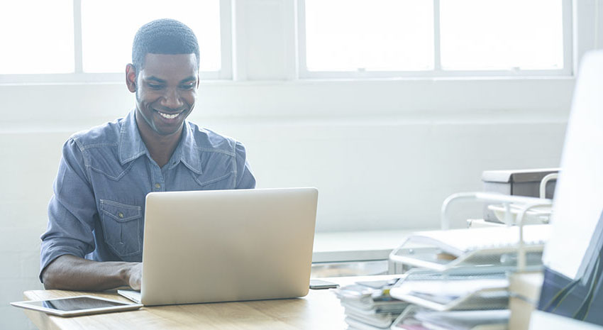 Happy man using laptop