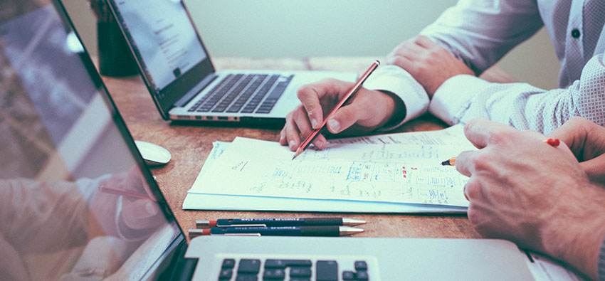 Two people reviewing business files