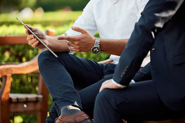 business men outside with tablet
