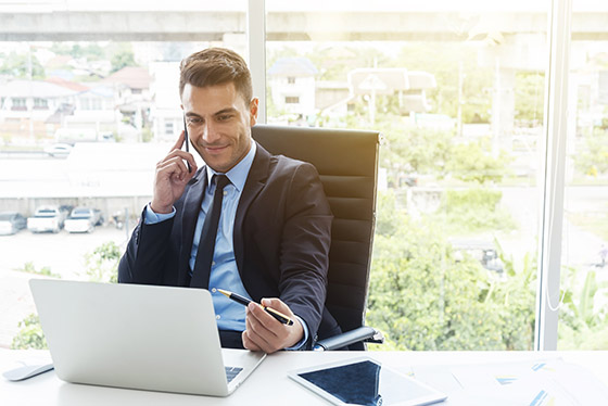 Business man on phone using computer