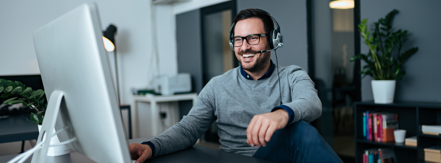 Friendly representative with headset works with customer over the phone