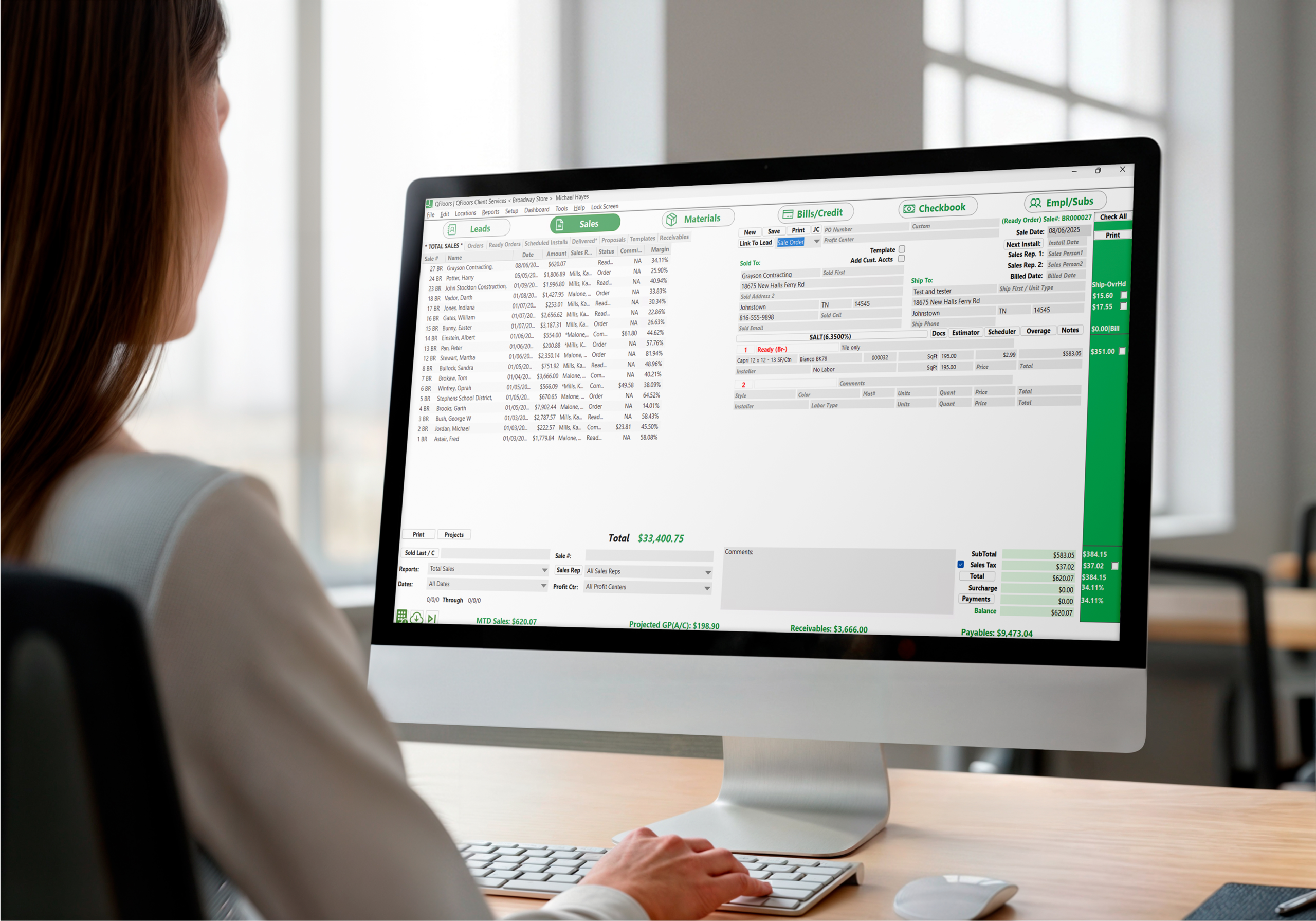 Woman working on QFloors desktop computer 